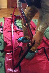 guy wearing booties with a dolly and pink blower door tent